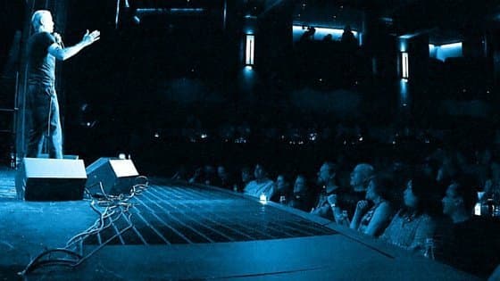Stand-up comedian performing on stage in front of an audience